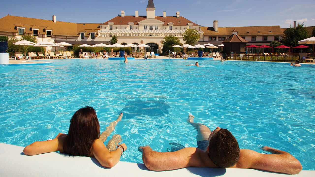 Couple enjoying outdoor pool in front entrance