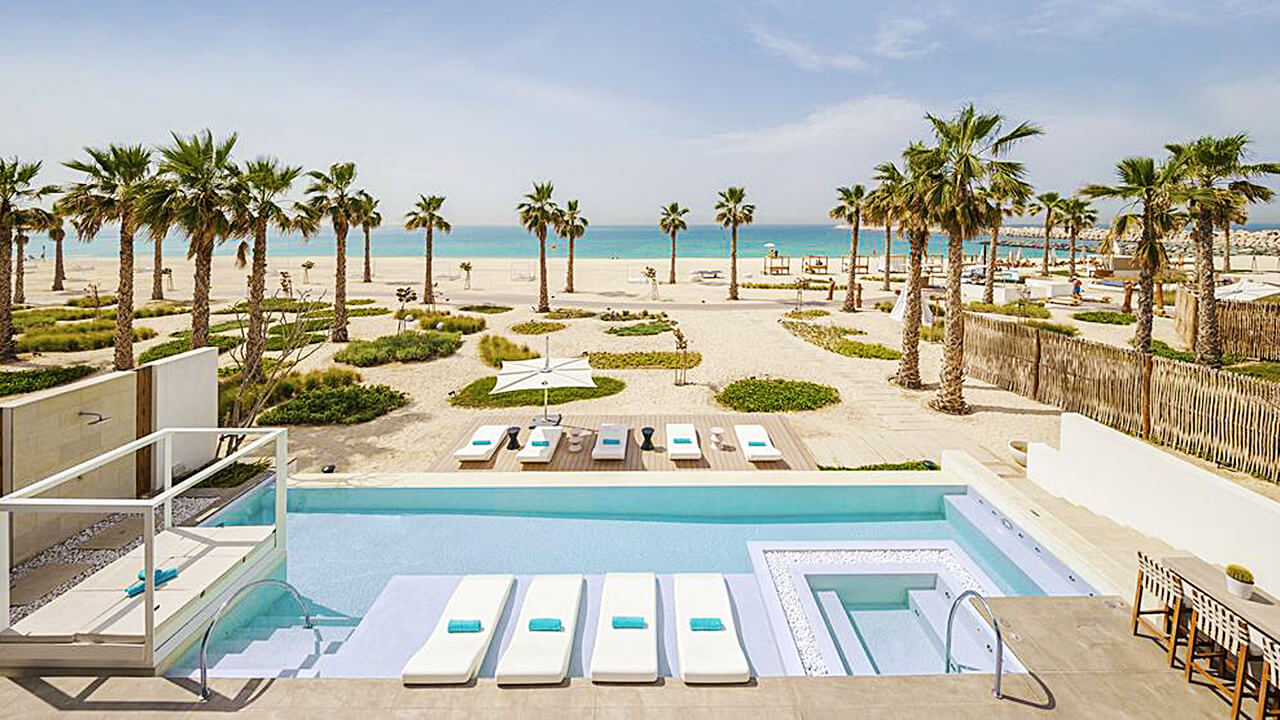 Nikki Beach Resort and Spa Outdoor swimming pool beach view