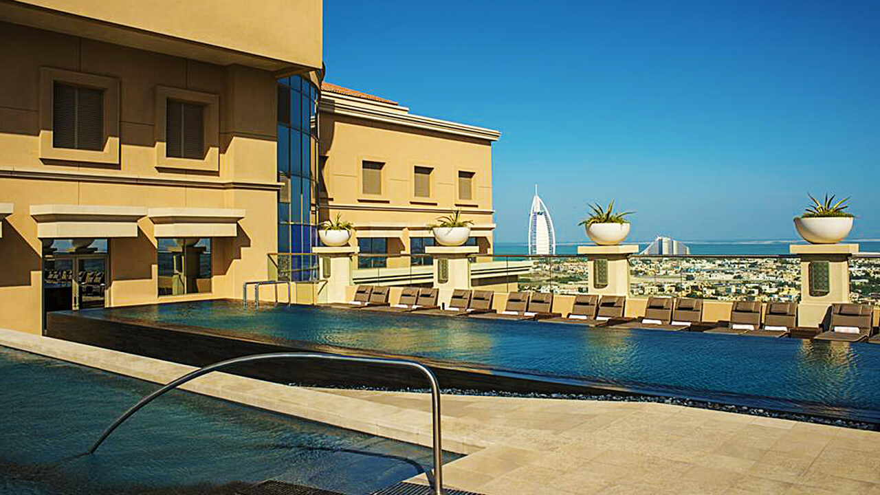 Sheraton Mall of the Emirates hotel outdoor Swimming pool with Burj al arab and city